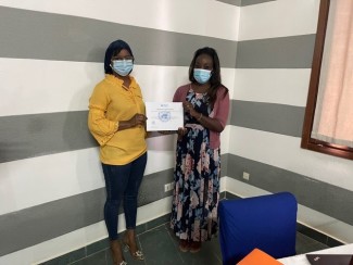 Dr Khouredia Ndiaye receives her training certification from UNODC Senegal National Program Coordinator