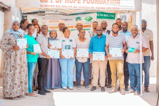 Honourable Kassimu Amar Mbaraka Makbel, Member of Parliament for Tanga City, in a group photo with URC Allies participants at the end of the training.